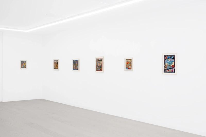 Six small framed works arranged across white gallery walls.