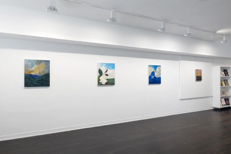 Installation view of four paintings displayed across a long white gallery wall.